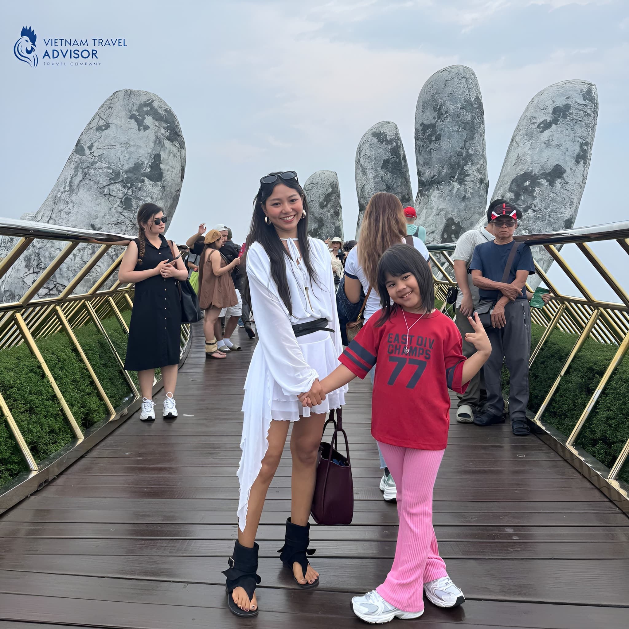Family travelers visiting Golden Bridge in Vietnam with scenic mountain views.